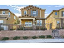 Two-story house with brown exterior, gray shutters, and a small front yard at 3615 Bitonto Ln, Henderson, NV 89044