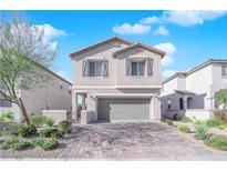 Two-story house with gray siding, gray garage door, and landscaped yard at 4823 Kinworthy St, North Las Vegas, NV 89081