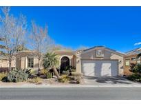 Single-story home with white garage door and landscaped front yard at 5026 Vincitor St, Las Vegas, NV 89135