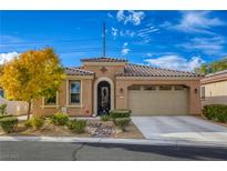 Single-story home with tan exterior, arched entryway, and landscaped yard at 5741 Pleasant Palms St, North Las Vegas, NV 89081