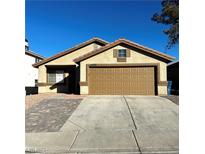 Single-story house with a two-car garage and a paved driveway at 6560 Bush Clover Ln, Las Vegas, NV 89156