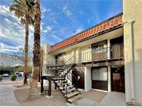 Two-story building with Spanish tile roof, balconies, and stairs at 1405 Vegas Valley Dr # 337, Las Vegas, NV 89169