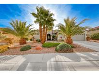 Single-story home with desert landscaping and palm trees at 2373 Rosendale Village Ave, Henderson, NV 89052