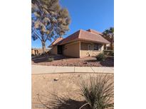 Tan colored house with a tile roof and small front yard at 2567 Paradise Village Way, Las Vegas, NV 89120