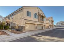 Charming townhome with multiple front-facing garages and a neutral stucco finish in a well-maintained neighborhood at 3309 Jamaica Princess Pl # 3, North Las Vegas, NV 89084