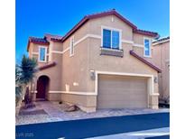 Tan two-story house with a red roof and a two-car garage at 4520 Lemon Gems Ct, Las Vegas, NV 89130