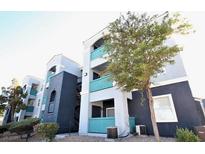 Modern apartment building with teal accents and landscaping at 6955 N Durango Dr # 1085, Las Vegas, NV 89149