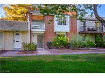 Brick front of charming two-story home with balcony and landscaped yard at 796 Tam O Shanter, Las Vegas, NV 89109