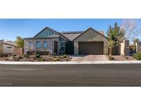 Single-story home with a modern design, two-car garage, and landscaped front yard at 8435 Great Outdoors St, Las Vegas, NV 89166