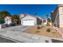 Charming single-story home featuring a two-car garage and xeriscaped front yard for easy maintenance at 8712 Majestic Pine Ave, Las Vegas, NV 89143