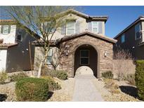 Two-story house with stone accents and a welcoming front porch at 1023 Desert Dome Ave, North Las Vegas, NV 89086