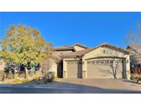 Beautiful two-story home with a three-car garage and desert landscaping at 10328 Planter Box St, Las Vegas, NV 89178