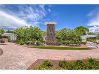 Attractive community entrance with brick pathway, landscaping, and a welcoming sign at 10546 Hartford Hills Ave, Las Vegas, NV 89166