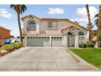 Two-story house with a three-car garage and landscaped yard at 1138 Aspen Valley Ave, Las Vegas, NV 89123