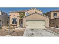 Two-story house with beige exterior, attached garage, and landscaping at 2108 Royal Antilles Ct, North Las Vegas, NV 89031