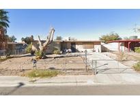 Single-story home featuring desert landscaping, a gated entrance, and a concrete driveway at 2529 San Marcos St, Las Vegas, NV 89115