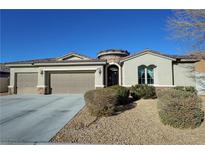 Single-story house with a three-car garage and desert landscaping at 2558 Sparrow Way, Pahrump, NV 89048