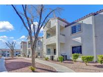 Exterior of a light-colored building with walkway and landscaping at 3318 N Decatur Blvd # 2047, Las Vegas, NV 89130