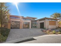 Stunning contemporary home with a three-car garage and landscaped front yard at 39 Cranberry Cove Ct, Las Vegas, NV 89135