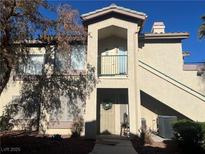 Two-story condo building with Spanish-style architecture and a balcony at 5710 E Tropicana Ave # 2148, Las Vegas, NV 89122