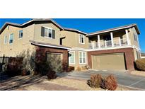 Two-story house with brick and siding, two-car garage, and landscaped yard at 7458 Mezzanine View Ave, Las Vegas, NV 89178