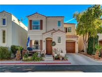 Charming two-story home featuring a lovely front porch, attached garage, and well-maintained landscaping at 10374 Midnight Iris St, Las Vegas, NV 89183