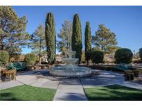 Community fountain with benches, landscaping, and tall trees at 1349 Via Savona Dr, Henderson, NV 89052