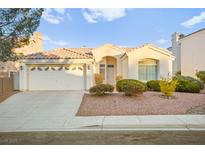 Single-story house with a two-car garage and well-maintained landscaping at 2260 Norway Pine Ct, Las Vegas, NV 89134