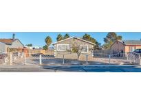 Cute single story home with a landscaped front yard and white iron fence at 2708 Bello Dr, North Las Vegas, NV 89030