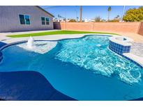Inviting kidney-shaped pool with a water feature at 3556 Valley Lily St, North Las Vegas, NV 89032
