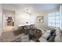 Bright dining area features a table, chairs, and sofa at 7779 Parnell Ave, Las Vegas, NV 89147