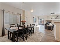 Bright dining room with a spacious table and six chairs, hardwood floors, and a chandelier at 9077 Camp Light Ave # 103, Las Vegas, NV 89149