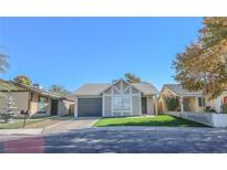 Cute single story home with artificial turf and gray garage door at 1354 Bradhurst Ct, Las Vegas, NV 89142