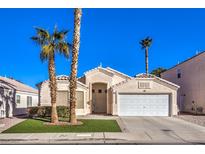 Single-story house with a white garage door and desert landscaping at 1570 Raining Hills St, Henderson, NV 89052