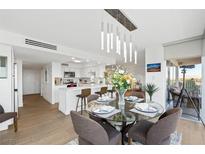 Bright dining area with glass table and modern lighting at 3111 Bel Air Dr # 7F, Las Vegas, NV 89109