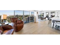 Bright living room featuring cozy armchairs, hardwood floors, and floor to ceiling windows with a scenic view at 3111 Bel Air Dr # 7F, Las Vegas, NV 89109