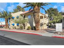Two-story building exterior with palm trees and a walkway at 4752 Obannon Dr # D, Las Vegas, NV 89102