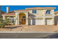 Two-story house with a brick driveway and a three-car garage at 6250 Pale Pavilion Ave, Las Vegas, NV 89139