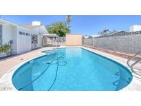 Inviting kidney-shaped pool, perfect for relaxation at 7220 Stormson Dr, Las Vegas, NV 89145