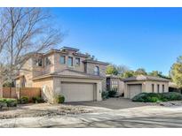 Two-story house with stone accents and a three-car garage at 29 Desert Highlands Dr, Henderson, NV 89052