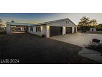 Ranch style home with three car garage and large driveway at 3950 Oakridge Ave, Pahrump, NV 89048