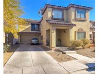 Two-story house with attached garage and desert landscaping at 4858 Longshot Dr, Las Vegas, NV 89122