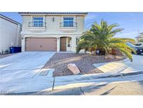 Two-story house with attached garage and desert landscaping at 6125 Cambiata Ct, Las Vegas, NV 89139