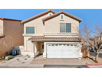 Beige two-story house with a white garage door and landscaping at 7194 Cestrum Rd, Las Vegas, NV 89113