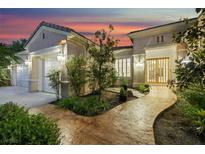 Inviting front entrance with mature landscaping and stone pathway leading to the glass-paneled front door at 1805 Prichard Ave, Henderson, NV 89052