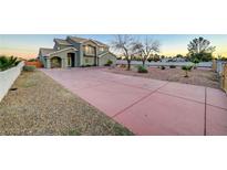 Two-story house with a large driveway and landscaped yard at 1964 Westwind Rd, Las Vegas, NV 89146