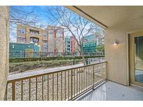 Cozy balcony view with a decorative garden and multi-story building in the background at 26 E Serene Ave # 124, Las Vegas, NV 89123