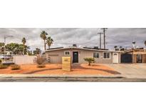 Beige single story home with landscaped front yard and a wooden house number sign at 2837 La Canada St, Las Vegas, NV 89169