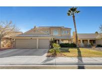 Two-story house with a beige exterior, two-car garage, and landscaping at 2875 Skowhegan Dr, Henderson, NV 89074