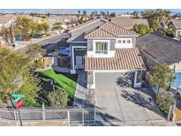 Charming two-story home featuring a well-manicured lawn, a secure fence, and a two-car garage at 3738 Falcon Springs Dr, Las Vegas, NV 89147